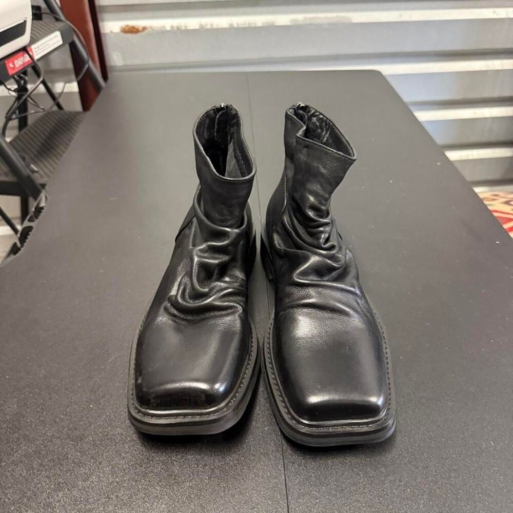 Black leather square toe boots with a grunge vibe